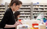 Pharmacist working by looking at medications